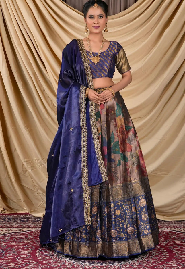 Woman wearing a traditional blue and patterned lehenga choli with dupatta