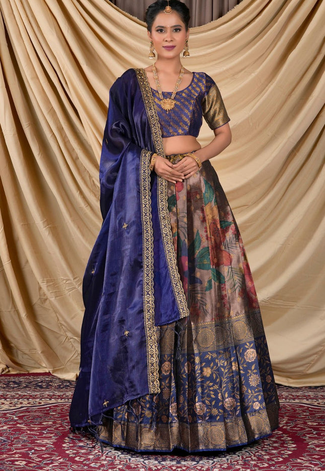 Woman wearing a traditional blue and patterned lehenga choli with dupatta