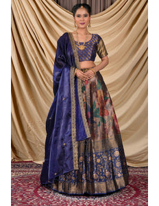 Woman wearing a traditional blue and patterned lehenga choli with dupatta