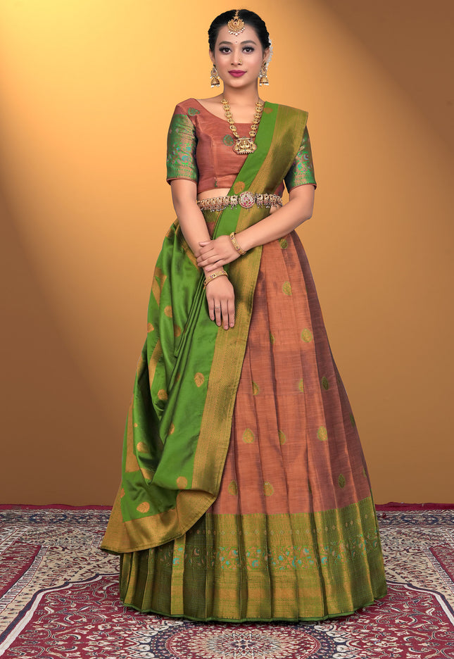 Woman wearing a traditional green and Bronze lehenga choli