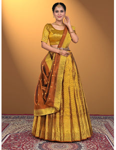 Woman wearing a traditional yellow and brown lehenga choli
