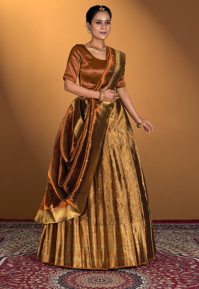 Woman wearing a traditional gold and bronze lehenga choli