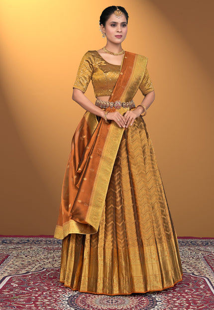 Woman wearing a traditional gold and brown lehenga choli