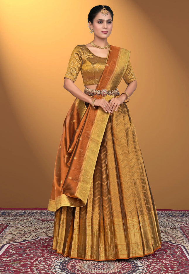 Woman wearing a traditional gold and brown lehenga choli