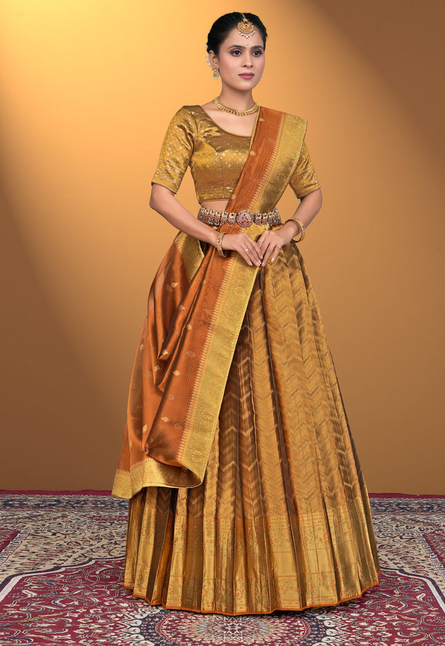 Woman wearing a traditional gold and brown lehenga choli