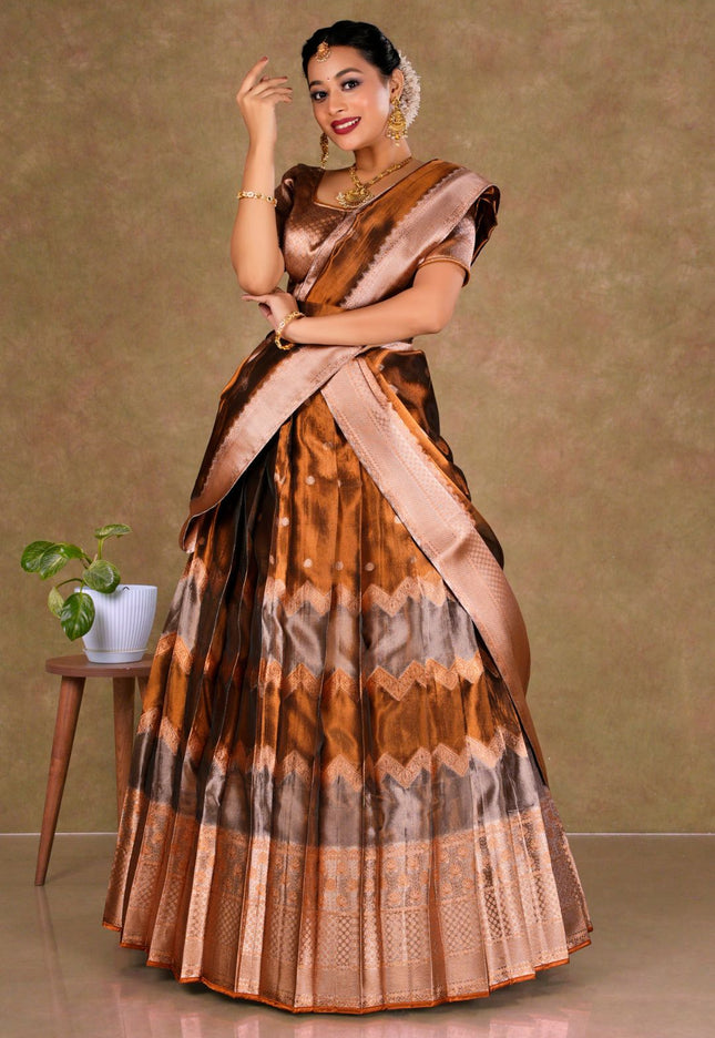 Woman wearing a traditional lehenga with a brown and beige pattern
