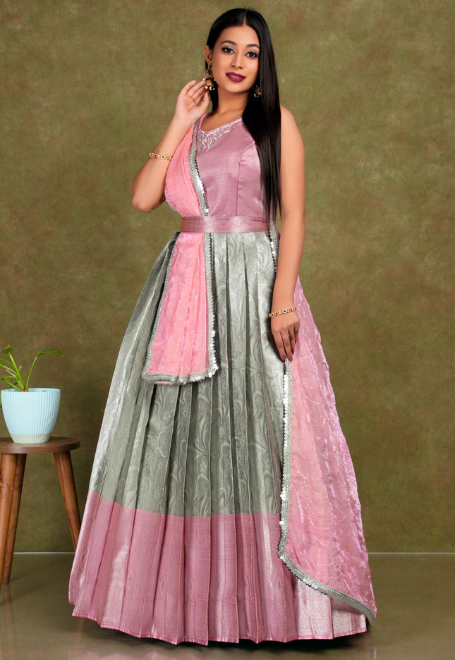 Woman wearing a pink and gray traditional lehenga choli with dupatta