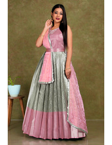 Woman wearing a pink and gray traditional lehenga choli with dupatta