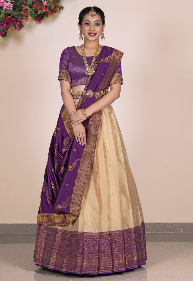 Woman wearing a traditional purple and beige lehenga