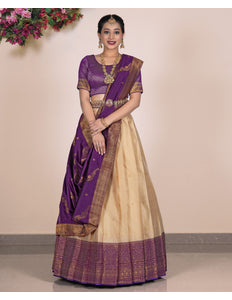 Woman wearing a traditional purple and beige lehenga