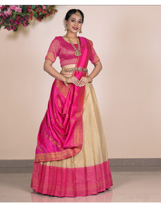 Woman wearing a pink and beige lehenga choli with dupatta