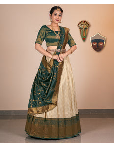 Woman wearing a traditional Chiku and beige saree with gold accents