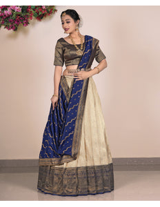 Woman wearing a traditional lehenga with a beige and blue pattern