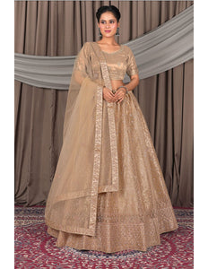 Woman wearing a traditional beige outfit with a dupatta