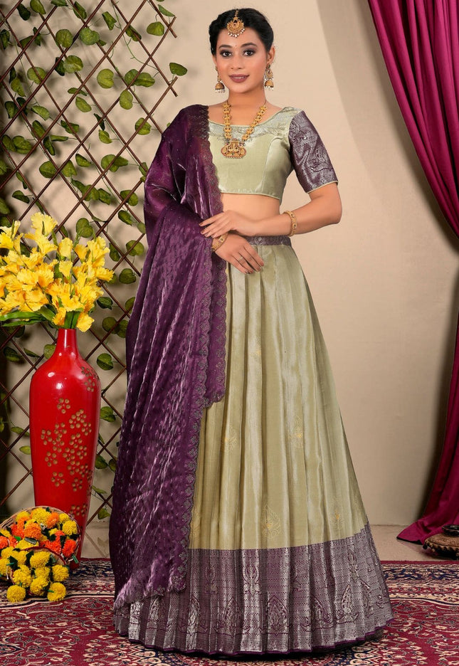 Woman wearing a chiku and purple lehenga choli with dupatta