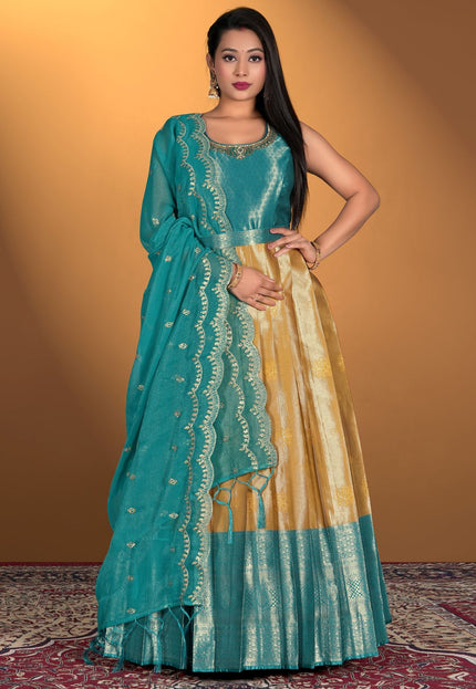 Woman wearing a traditional teal and gold gown 