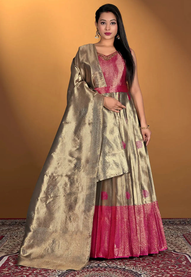 Woman wearing a traditional outfit with a gold dupatta