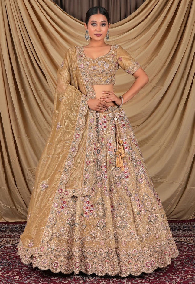 Woman wearing a traditional beige embroidered lehenga