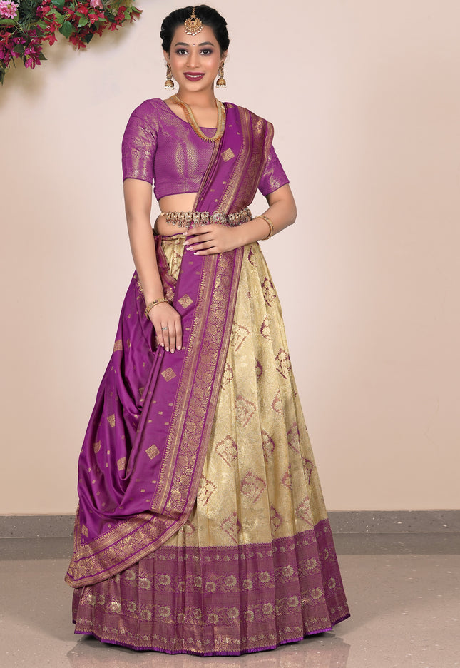 Woman wearing a purple and beige Lehenga Choli