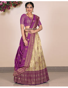 Woman wearing a purple and beige Lehenga Choli