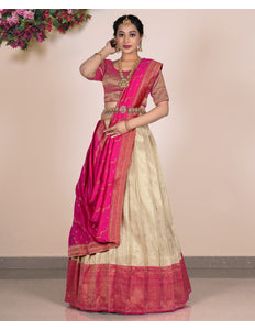 Woman wearing a pink and beige lehenga choli