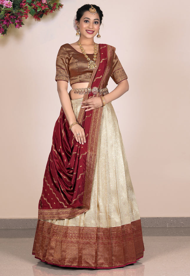 Woman wearing a traditional lehenga with a maroon and beige color scheme 