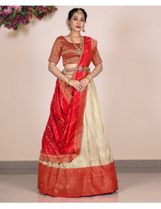 Woman wearing a red and beige lehenga