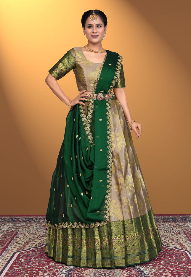 Woman wearing a beige lehenga with gold embroidery