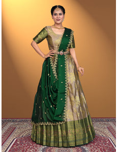 Woman wearing a beige lehenga with gold embroidery