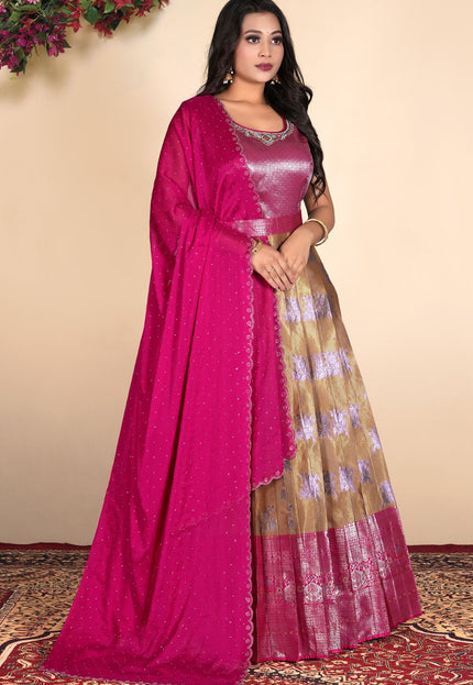 Woman wearing a pink and chiku gown with a patterned dupatta
