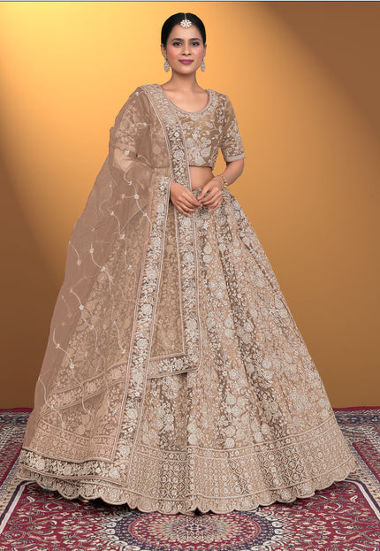 Woman in a traditional beige embroidered lehenga choli with dupatta