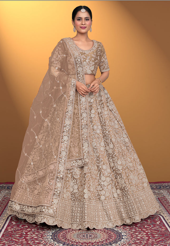 Woman in a traditional beige embroidered lehenga choli with dupatta
