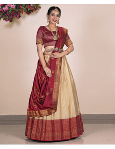 Woman wearing a traditional maroon and beige lehenga choli