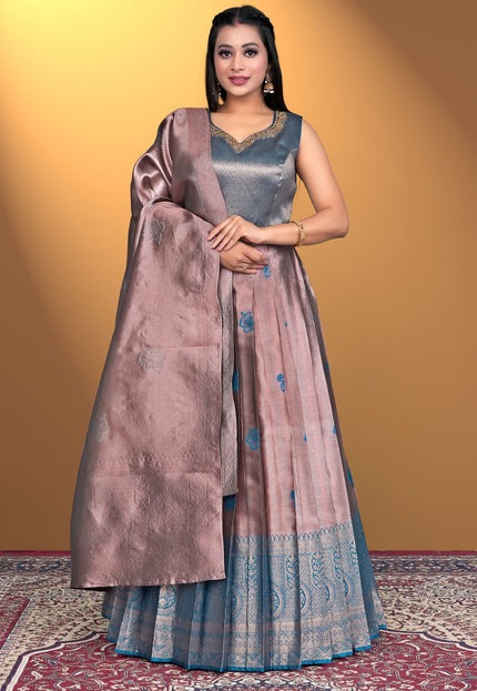 Woman wearing a traditional outfit with a brown dupatta
