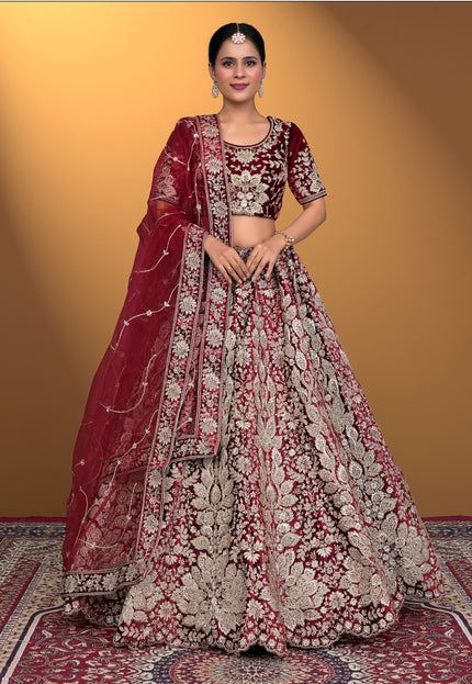 Woman wearing a traditional maroon and white embroidered lehenga