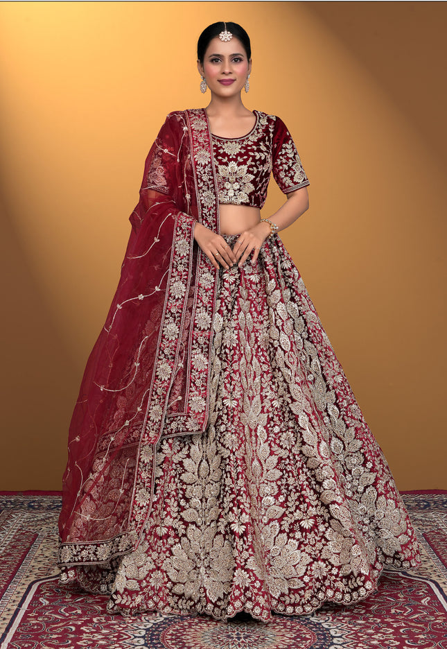Woman wearing a traditional maroon and white embroidered lehenga