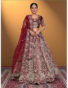 Woman wearing a traditional maroon and white embroidered lehenga