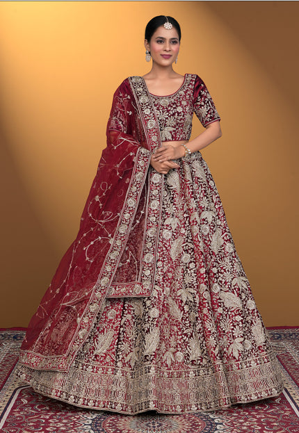 Woman wearing a traditional maroon and white embroidered outfit