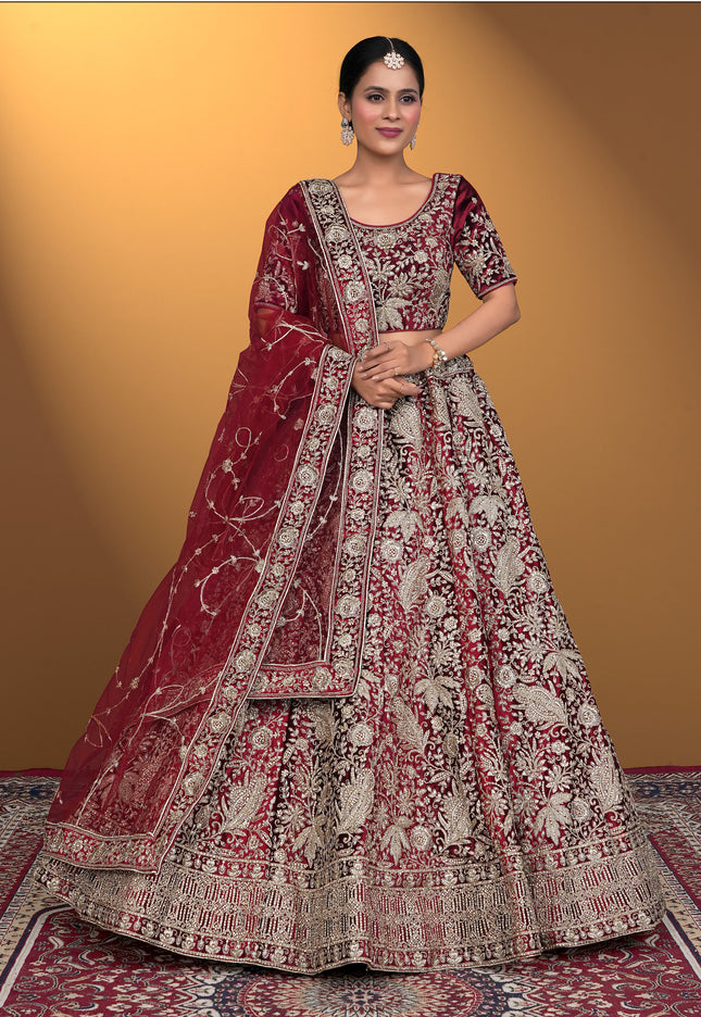 Woman wearing a traditional maroon and white embroidered outfit