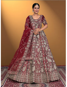 Woman wearing a traditional maroon and white embroidered outfit