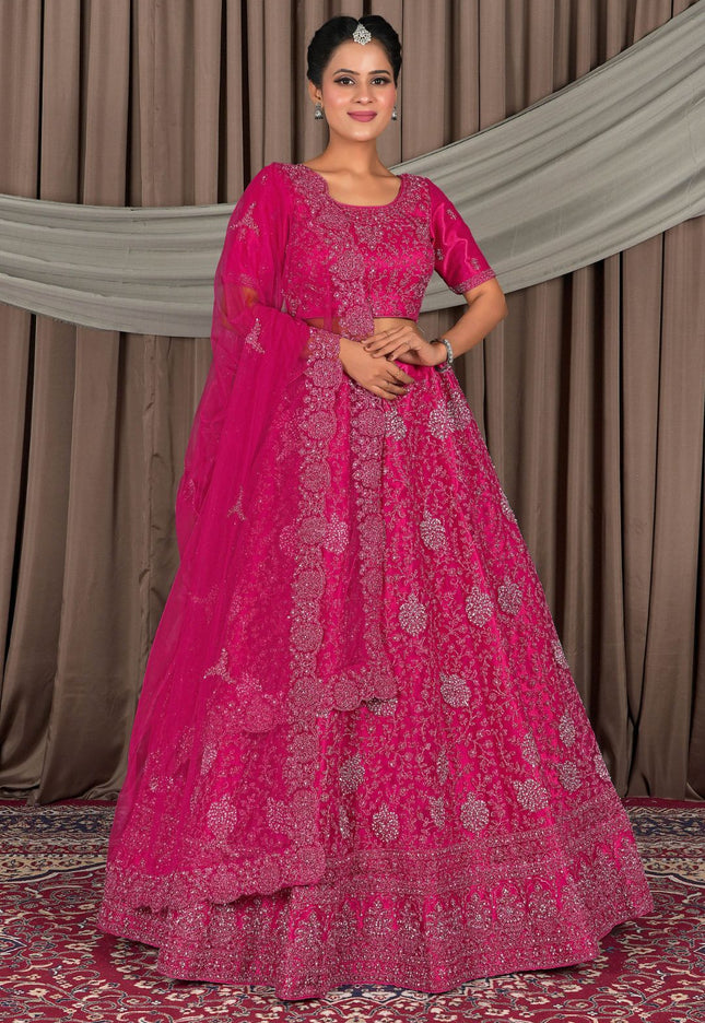 Woman wearing a pink traditional outfit with a matching dupatta