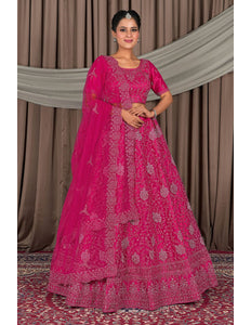 Woman wearing a pink traditional outfit with a matching dupatta