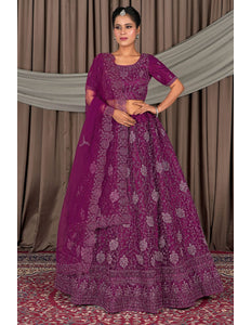 Woman wearing a traditional purple embroidered outfit