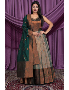 Woman wearing a traditional outfit with a green dupatta 