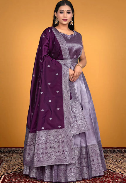 Woman wearing a traditional outfit with a purple and lavender patterned dress