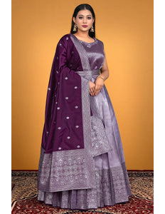 Woman wearing a traditional outfit with a purple and lavender patterned dress