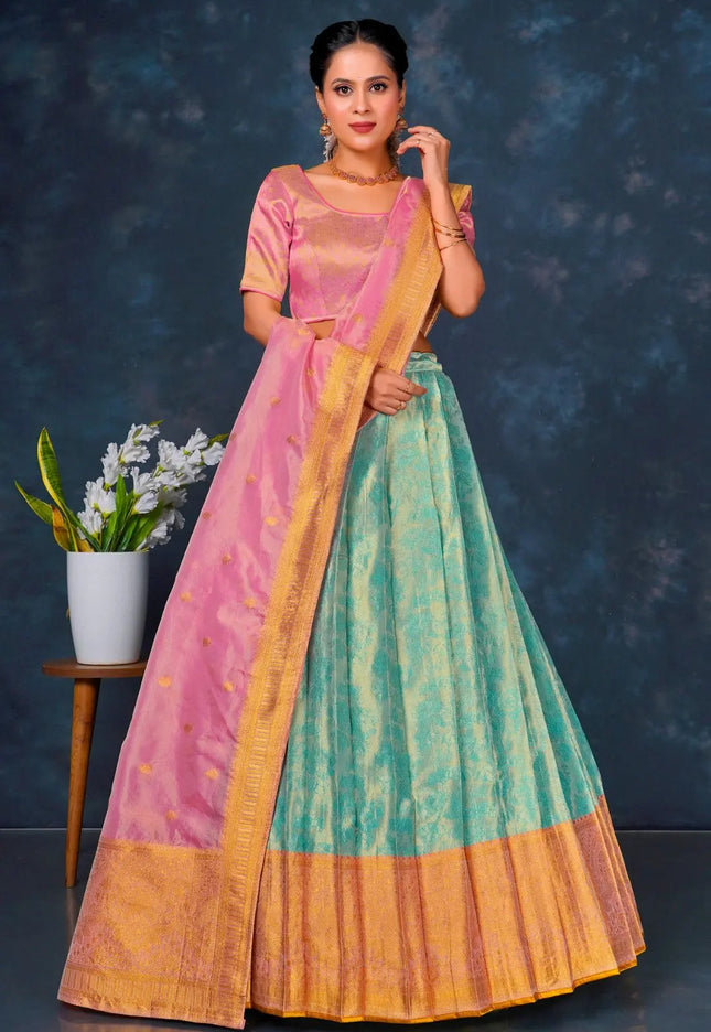 Woman wearing a traditional outfit with a pink blouse and green and orange skirt