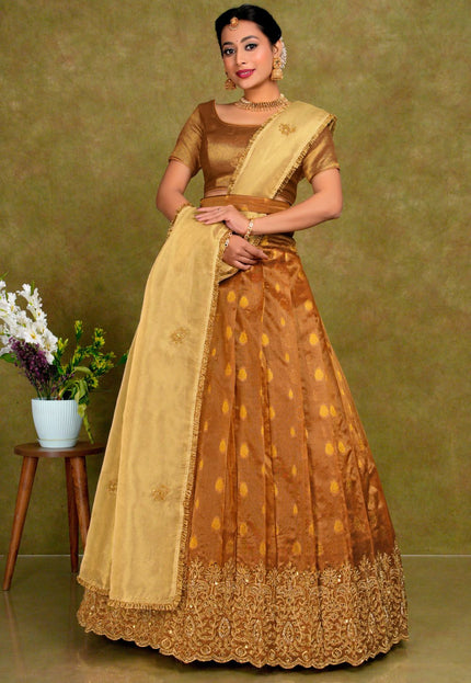 Woman wearing a traditional brown and beige lehenga choli with dupatta