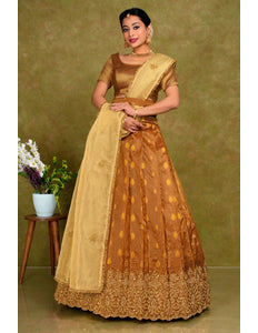Woman wearing a traditional brown and beige lehenga choli with dupatta