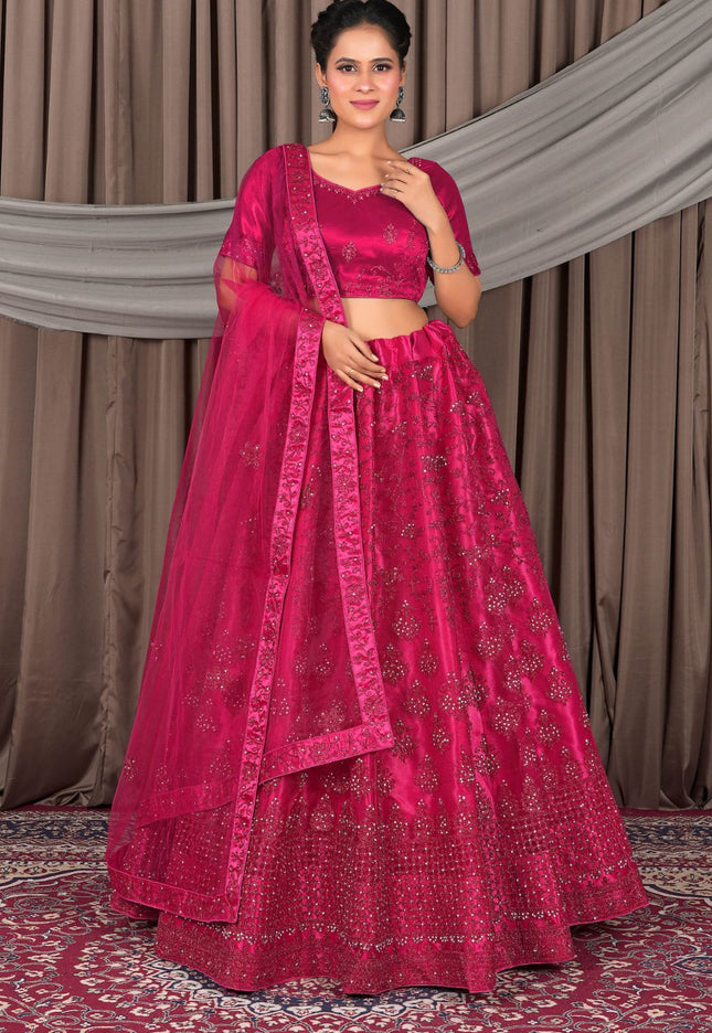 Woman wearing a traditional pink saree with a matching blouse